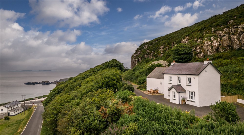 The exterior of Carrick-a-Rede Cottage, County Antrim at Castle Ward Bunkhouse in Downpatrick, County Down