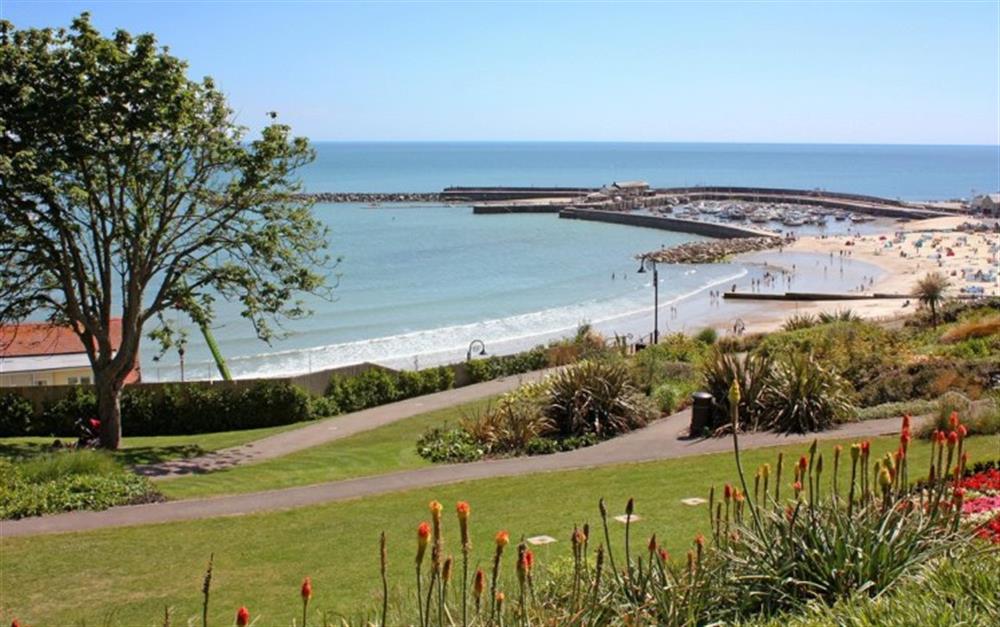 Nearby Lyme Regis - views across Langmoor gardens to the beach and Cobb Harbour at Cato Cottage in Bridport