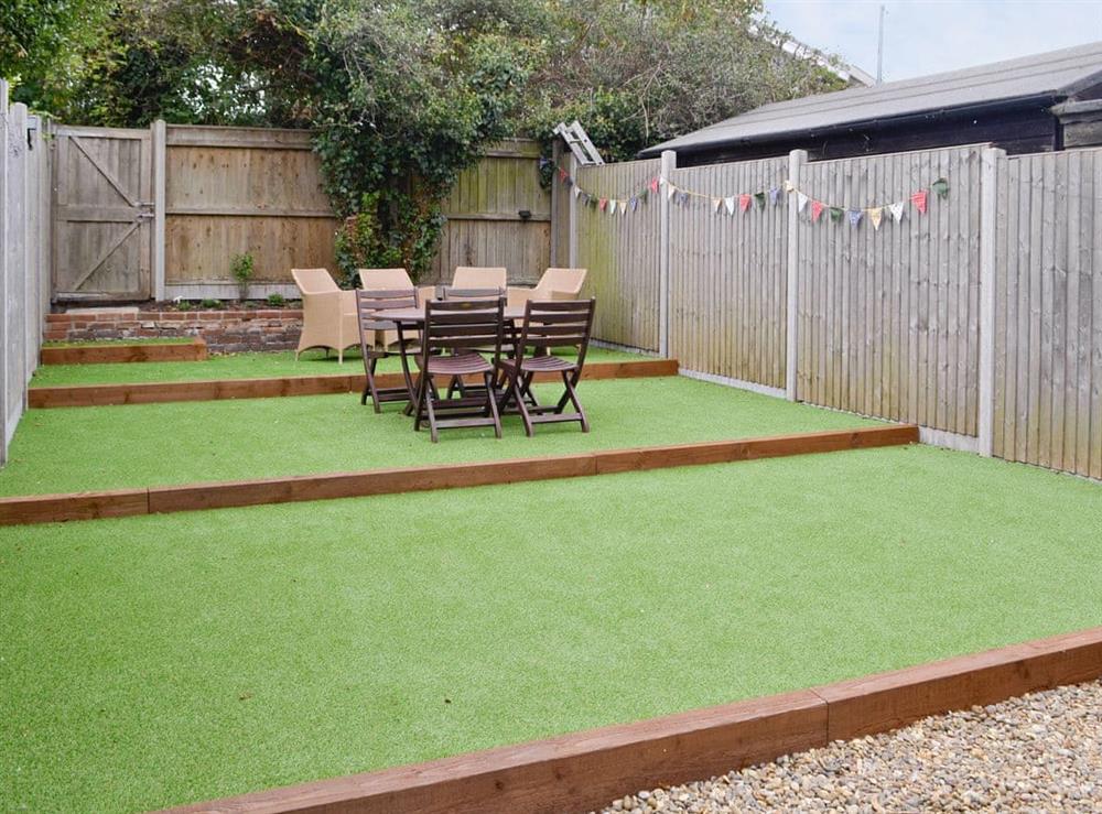 Enclosed patio/garden area with outdoor furniture at Cats Cottage in Kessingland, near Lowestoft, Suffolk