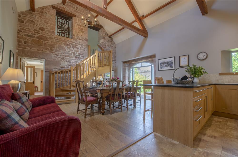 Open-plan kitchen and dining room with handmade oak staircase leading to the first floor at Cazenovia Hall and Wythburn Cottage, near Greystoke