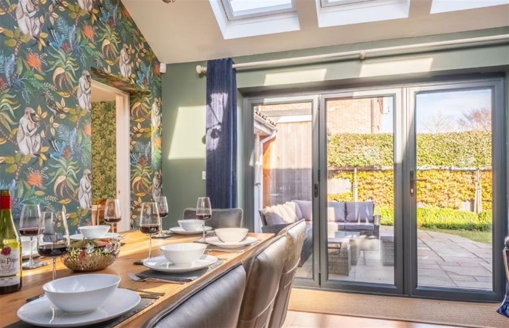 Dining area with bi-fold doors to the enclosed garden at Cedar House, Holt