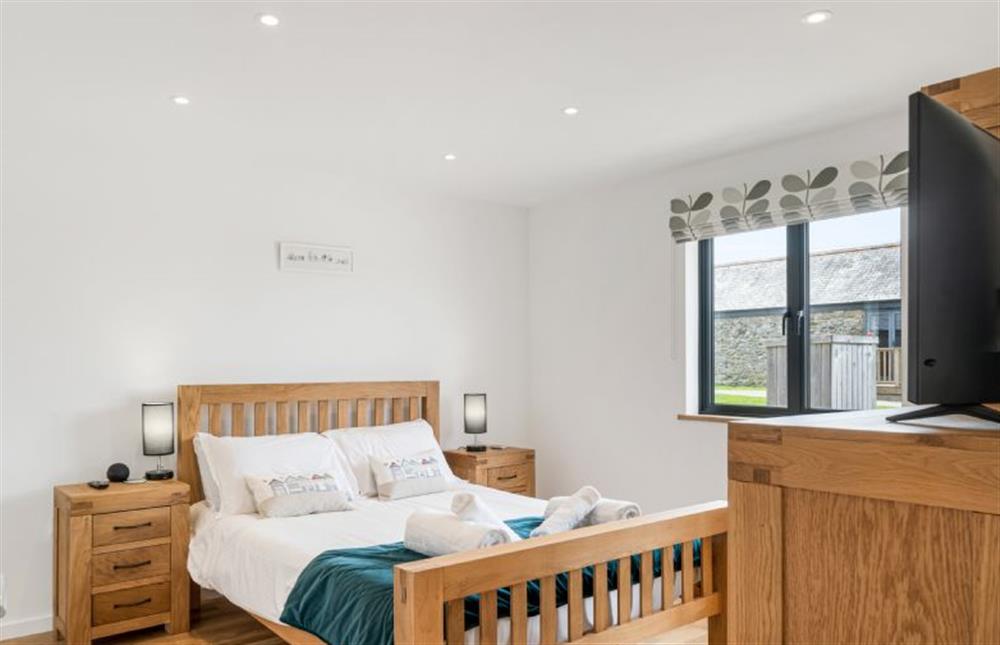 Bedroom one with a 5’ king-size bed, Smart television and en-suite at Cedar House, St Agnes