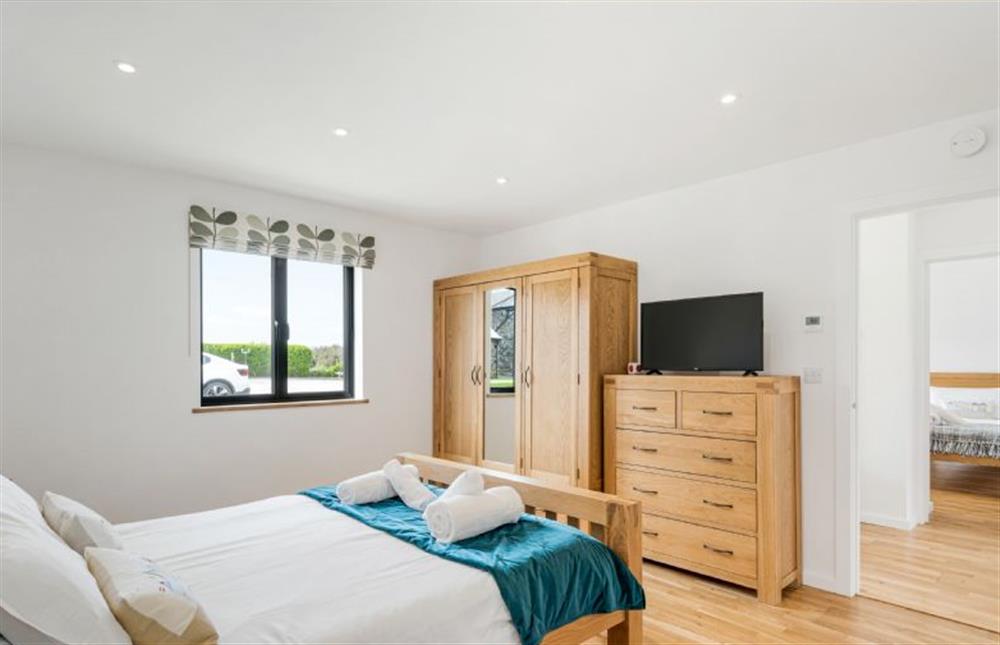 Bedroom one with a king-size bed, Smart television and en-suite at Cedar House, St Agnes