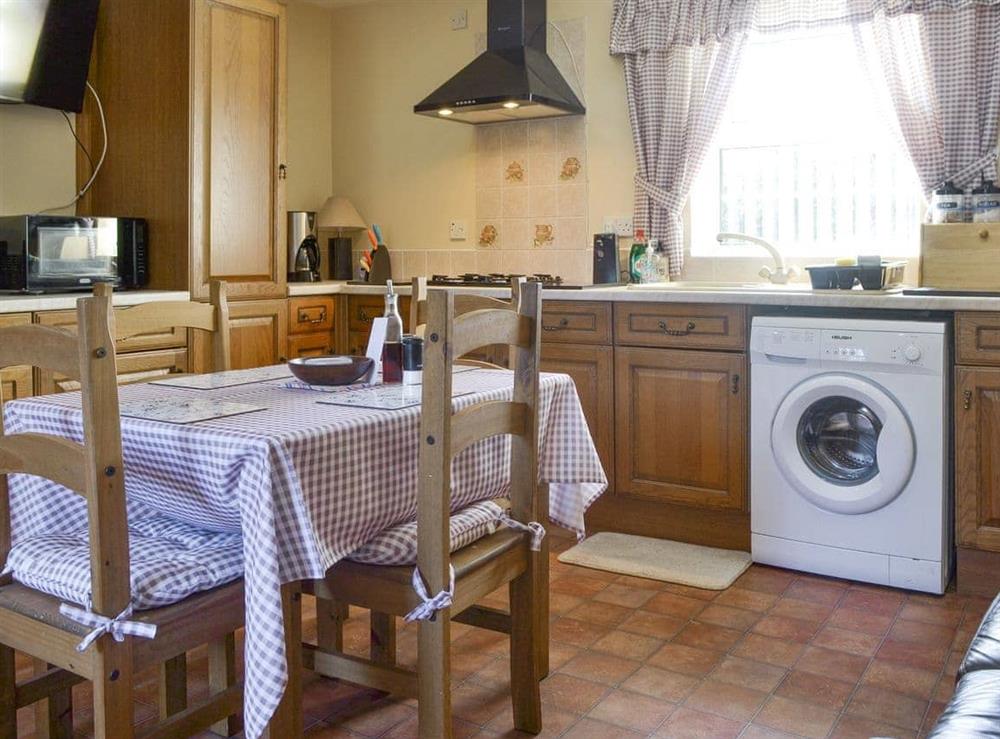 Convenient dining area within kitchen at Cefn Helyg Bach in Cemaes Bay, Gwynedd