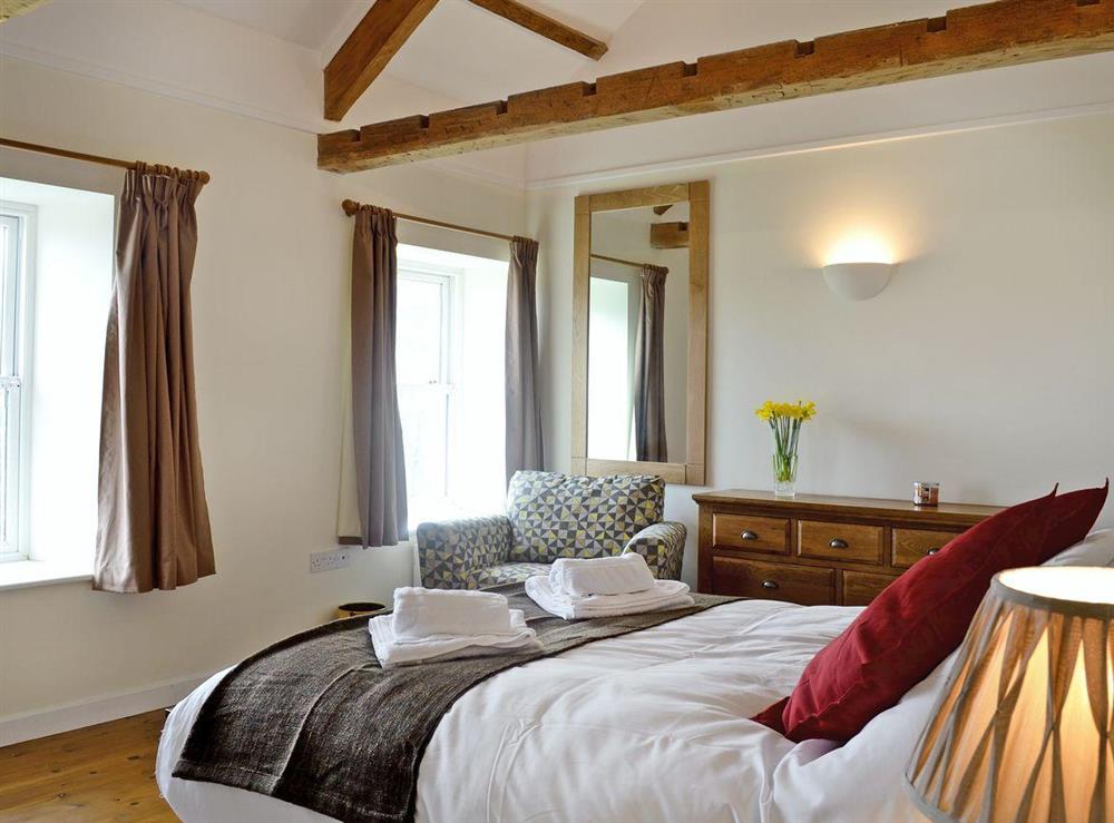 Elegant double bedroom with beamed ceiling at Dolgoed House, 
