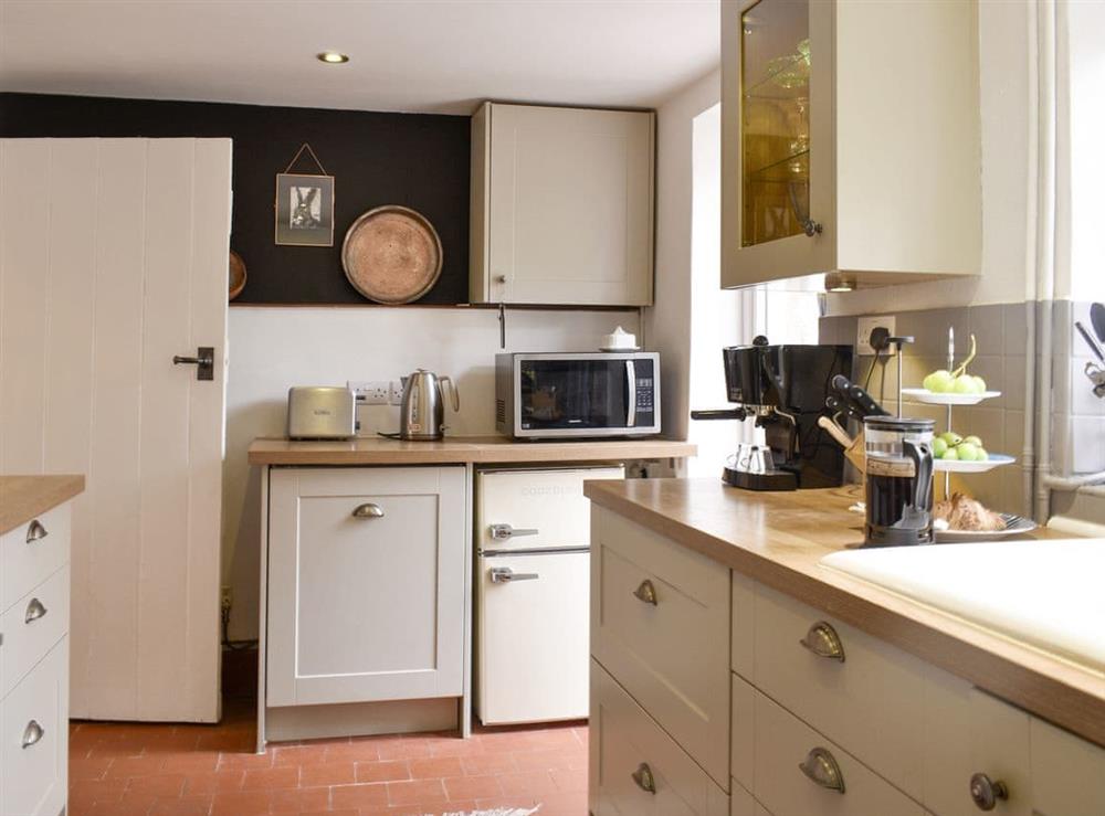 Well-equipped fitted kitchen at Cenwulf Cottage in Winchcombe, near Cheltenham, Gloucestershire