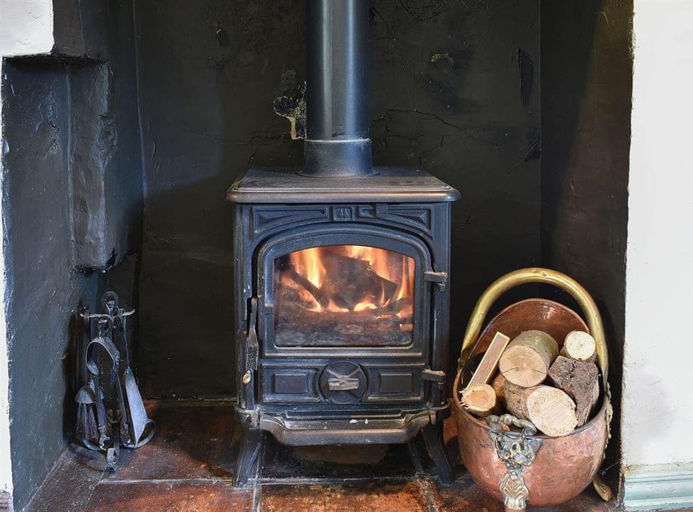 Cosy woodburner in the living area at Cerne Abbey Cottage in Cerne Abbas, Dorset., Great Britain