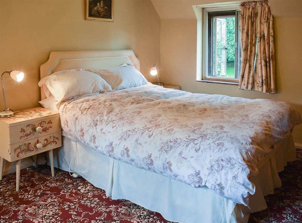 Pretty, spacious beamed double bedroom at Cerne Abbey Cottage in Cerne Abbas, Dorset., Great Britain