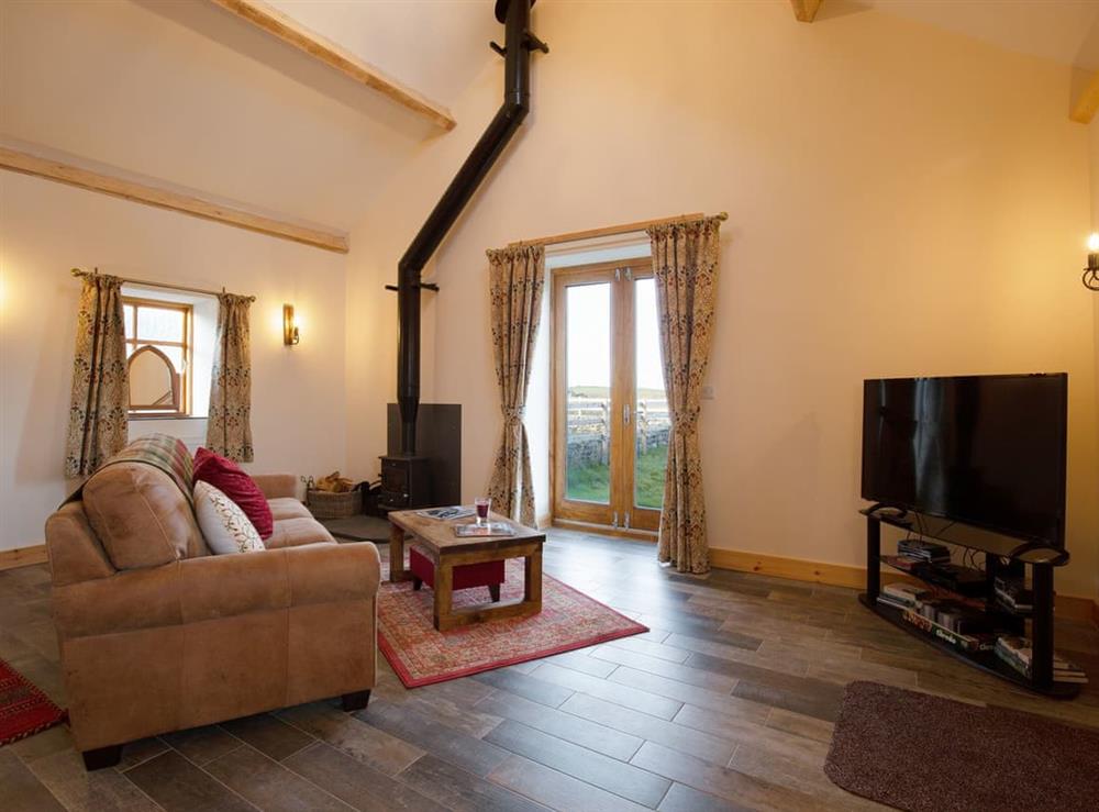 Stylish living room with wood burner at Curlew Cottage, 