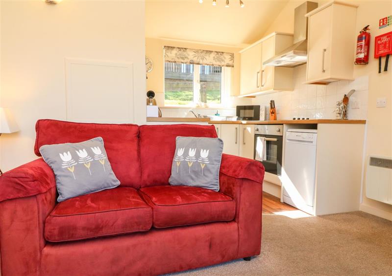 Relax in the living area at Chalet Log Cabin C11, Combe Martin
