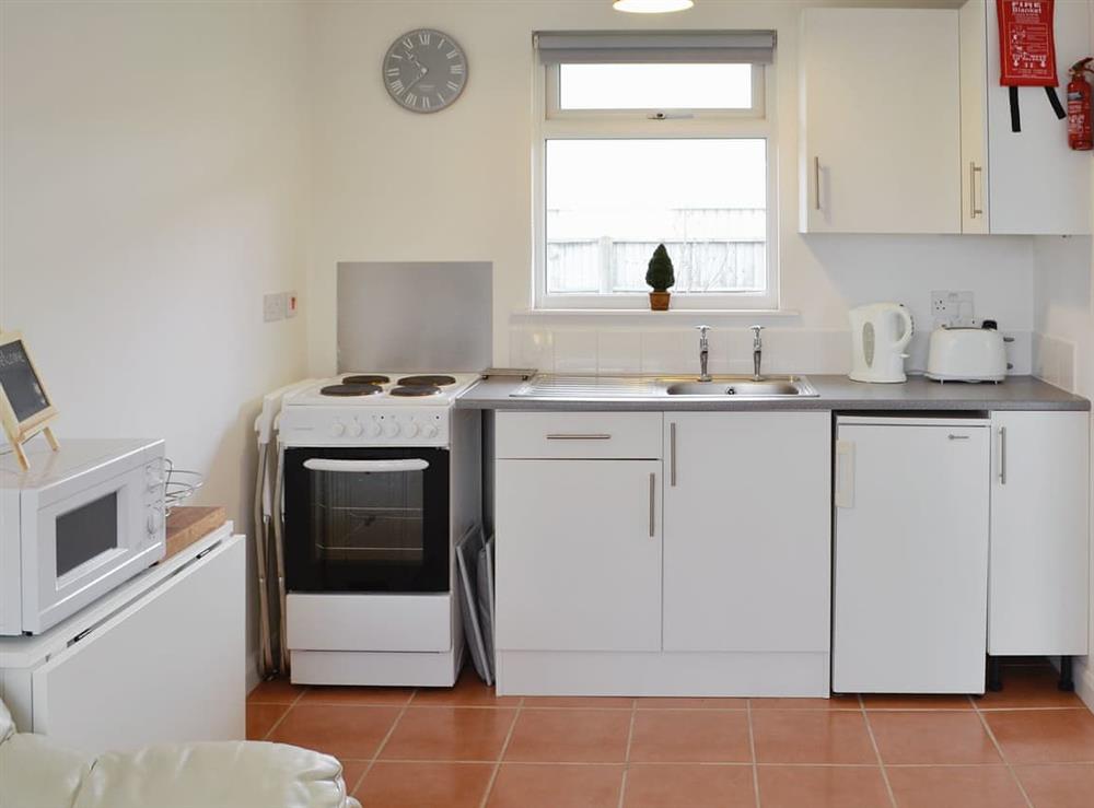 Quaint open plan living space at Chalet One in Bridport, Dorset