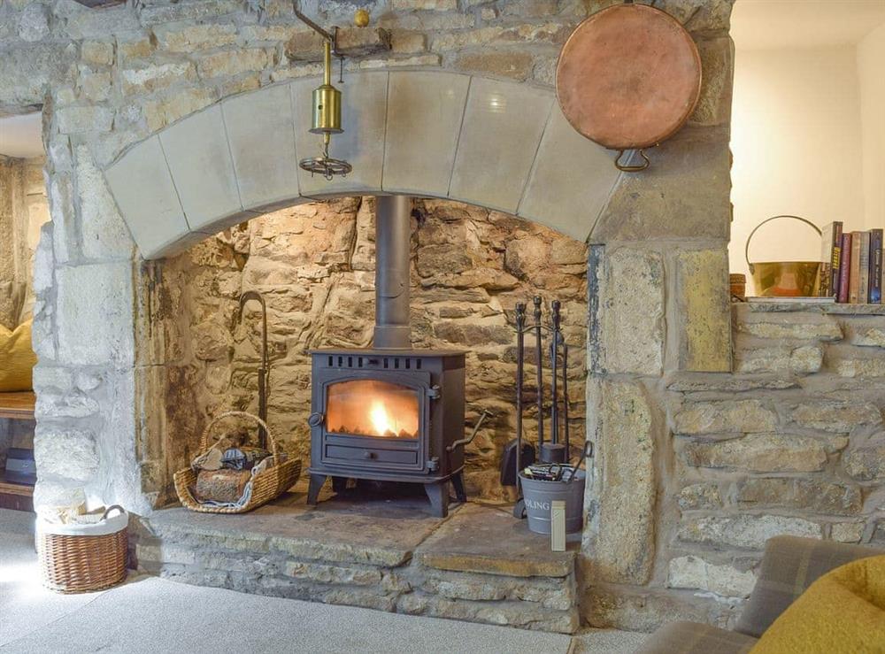 Outstanding stone fireplace with wood burner at Chamber End Fold in Grassington, near Skipton, North Yorkshire
