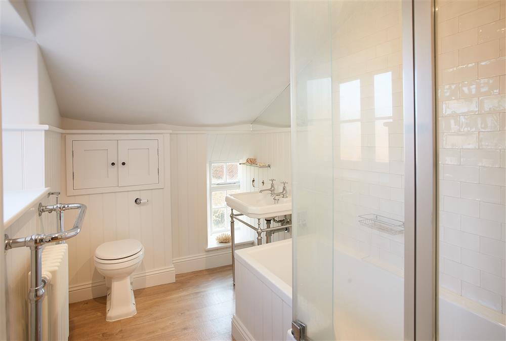 Bathroom with bath and overhead shower at Chanting Hill Farmhouse, Castle Howard Estate, Welburn
