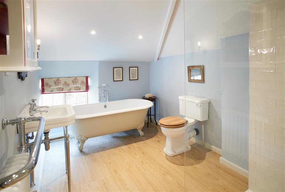 Bathroom with roll-top, claw-foot bath and separate walk-in shower cubicle at Chanting Hill Farmhouse, Castle Howard Estate, Welburn