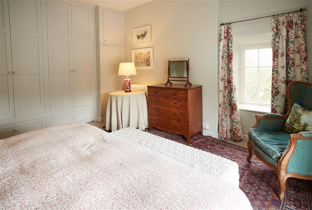 Bedroom one with super-king size bed and double aspect windows at Chanting Hill Farmhouse, Castle Howard Estate, Welburn