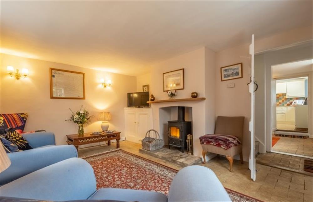 Sitting room with wood burning stove at Chantry Cottage, Blythburgh