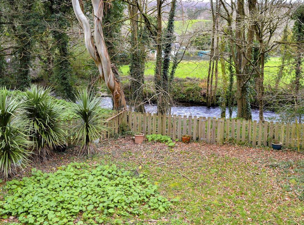 Camel River running past the garden at Chapel Barn in Bodmin, Cornwall, England