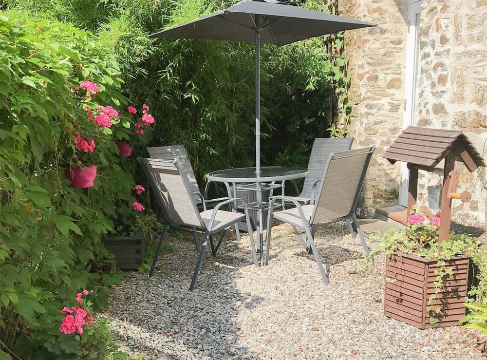 Intimate enclosed garden with seating at Chapel Barn in Bodmin, Cornwall, England