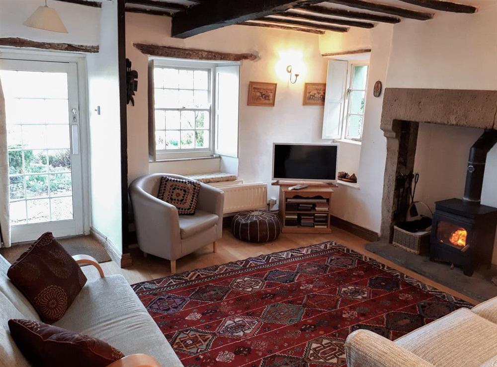 Living room with wood burner at Chapel Cottage in Penrith, Cumbria