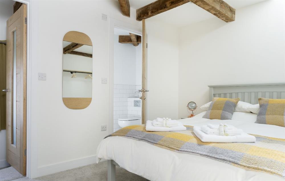 Master bedroom with 5’ king-size bed and en-suite shower room at Chapel House, Bampton