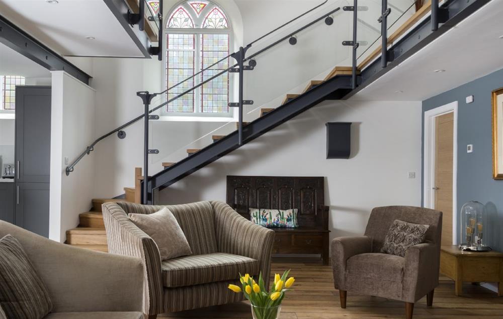 Open plan living area with stairs leading to the first floor mezzanine at Chapel House, Bampton