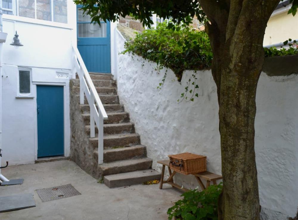 Enclosed courtyard with patio, garden furniture and BBQ at Chapel Street in Penzance, Cornwall
