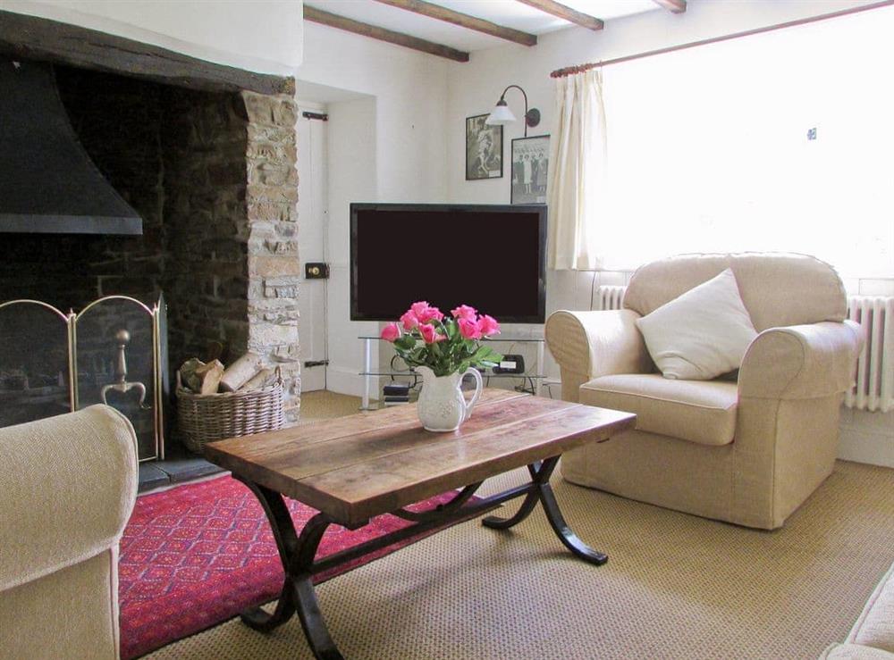 Cosy living room with large open fire at Chaplands in Beaford, near Great Torrington, Devon