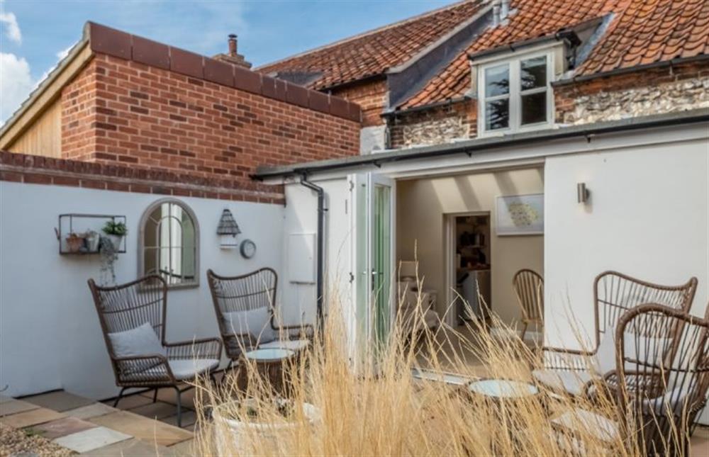 The bi-folding doors lead out onto the terraced garden at Charnwood Cottage, Burnham Market