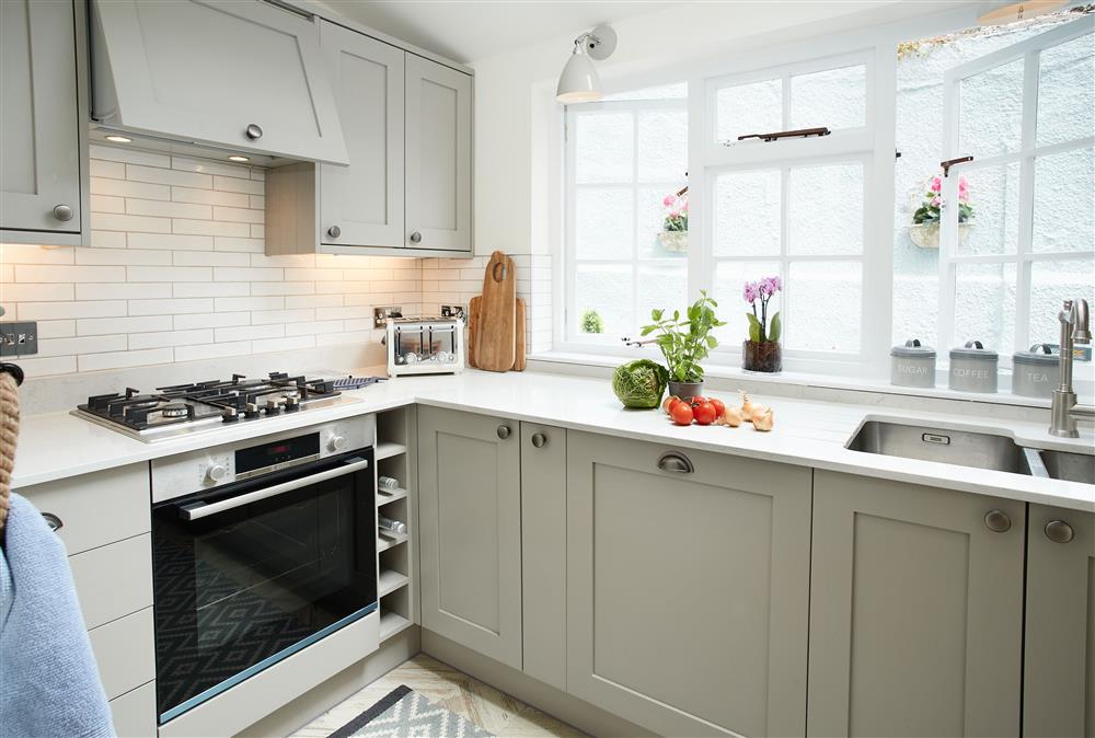 Ground floor: Well-equipped kitchen with door leading to rear terrace (photo 3) at Chart House, Tenby