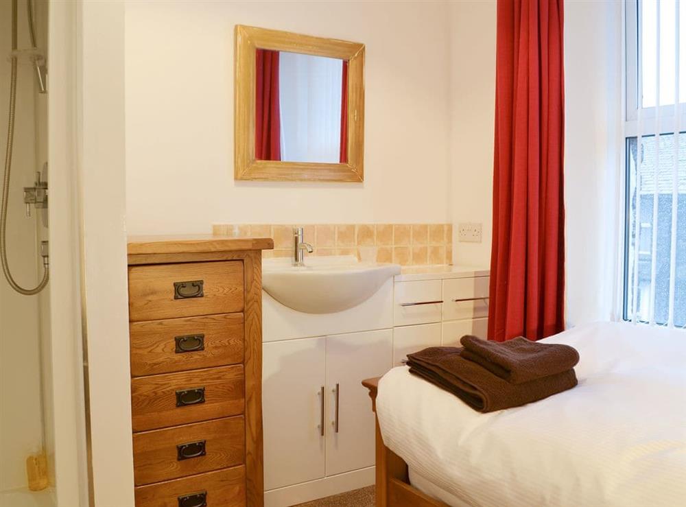 Single bedroom with vanity unit and en-suite shower room at Chartfield in Windermere, Cumbria