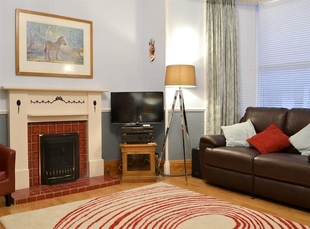 Spacious living room with lovely gas coal-effect fire at Chartfield in Windermere, Cumbria