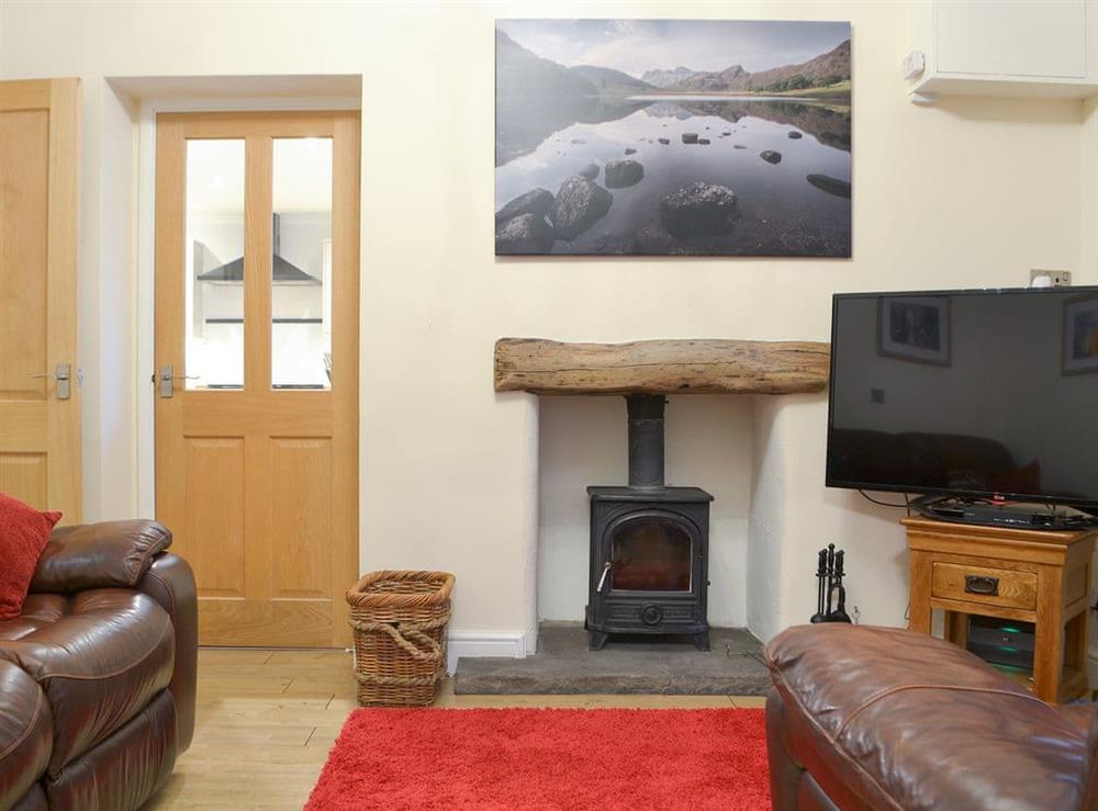 Warm and welcoming snug with wood burner at Chartfield in Windermere, Cumbria