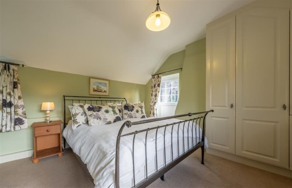 Bedroom two has a king-size bed and a balcony at Cheney Hollow, Heacham near Kings Lynn
