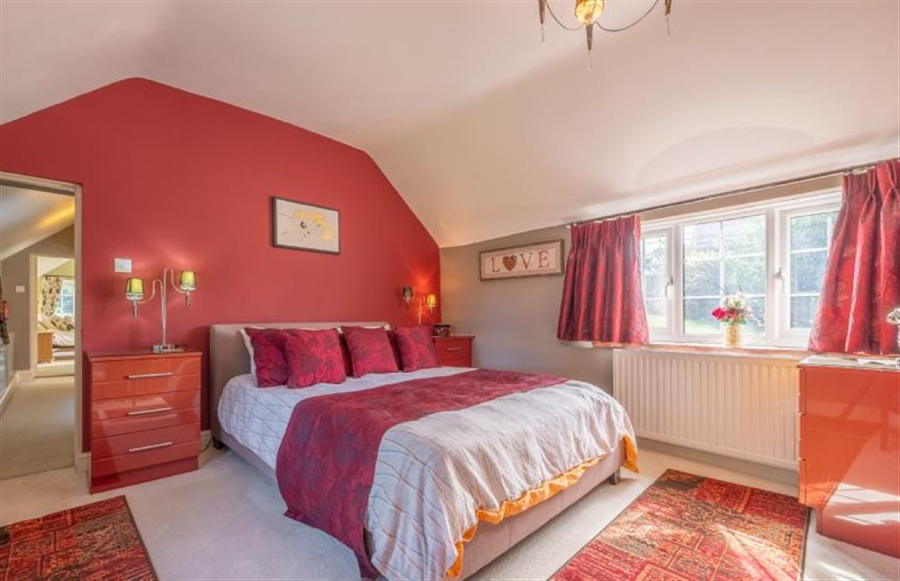 The master bedroom has a king-size bed at Cheney Hollow, Heacham near Kings Lynn