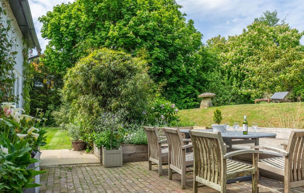 Enjoy the stunning garden views from the seating area at Cherry Cottage, Ripe