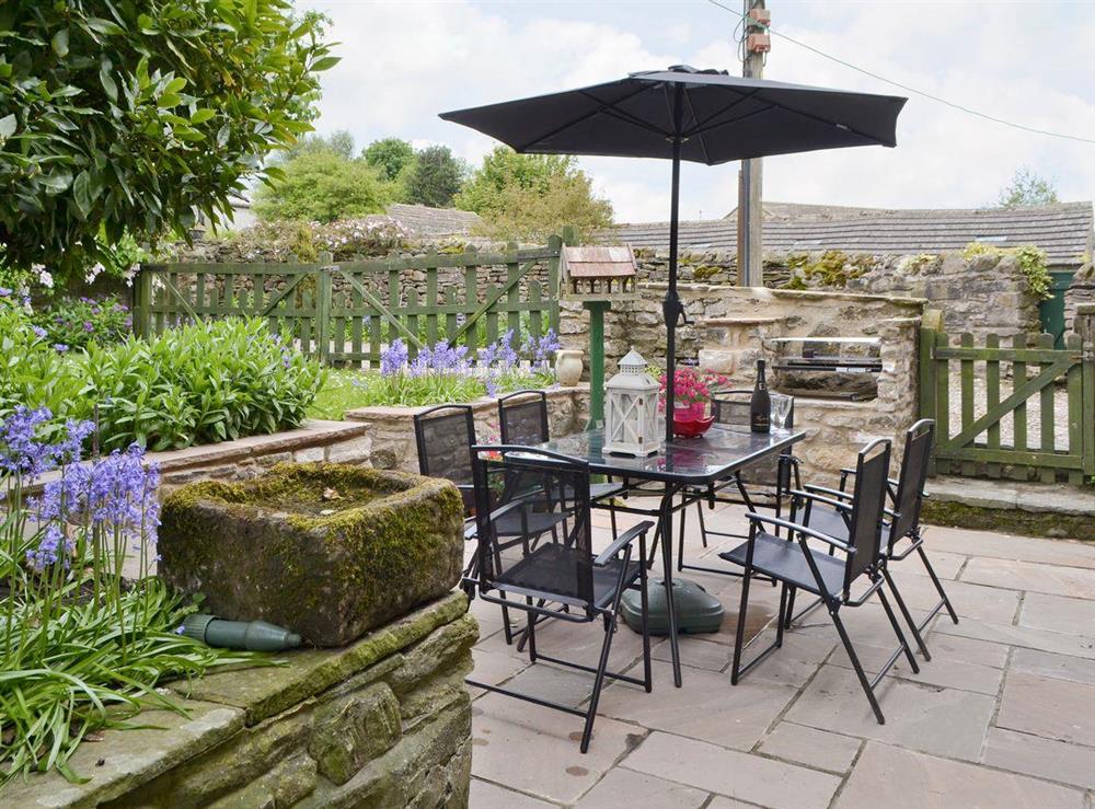 Outdoor eating area with built-in BBQ at Cherry Tree Cottage in Bellerby, Wensleydale., North Yorkshire