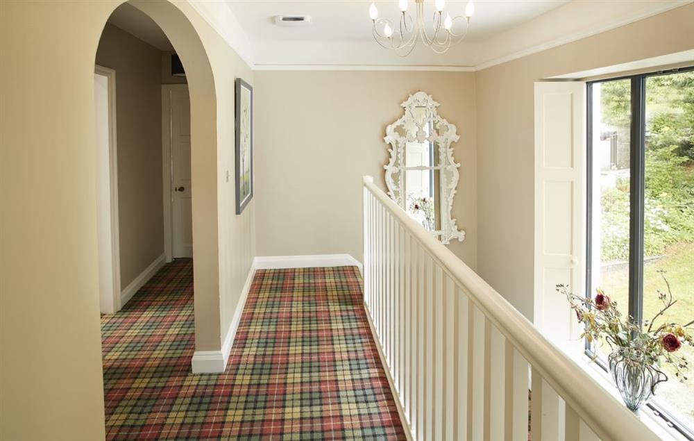 A traditional, feature staircase with large picture window overlooking the grounds leads to the first floor