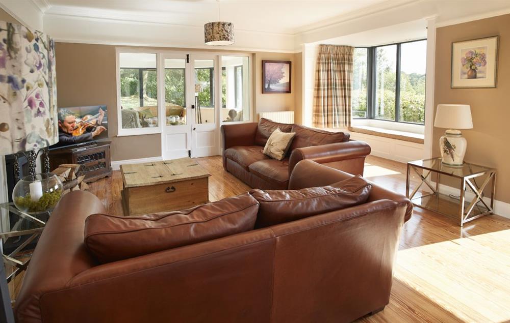 Beautiful sitting room with patio doors and bay window with views across the Lake at Cherry Trees, Bowness-on-Windermere