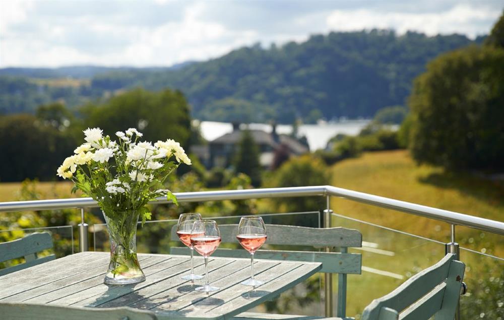 Large decking area with seating and outside dining areas at Cherry Trees, Bowness-on-Windermere