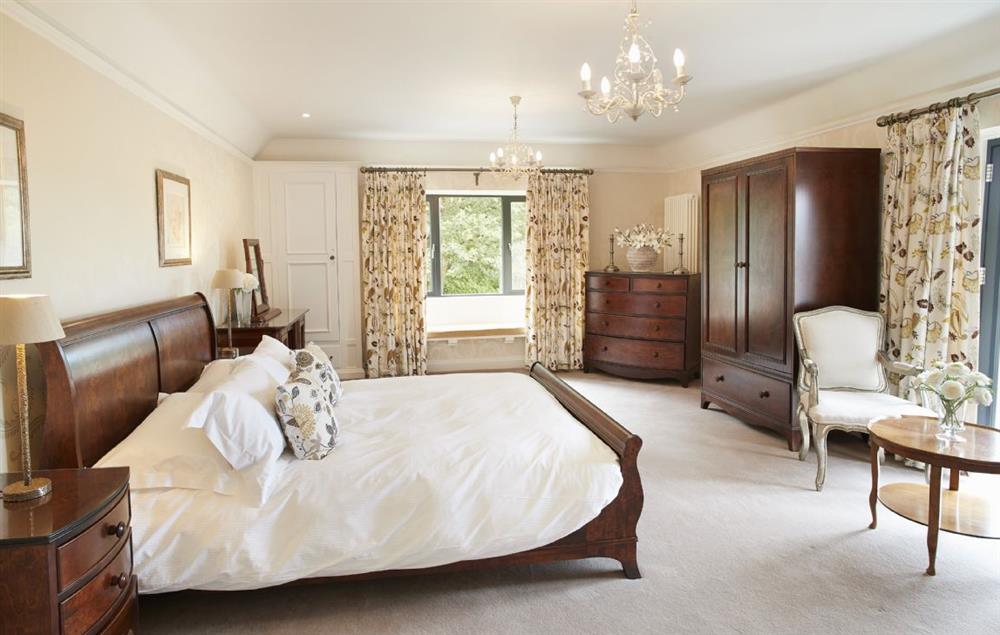 Spacious master bedroom with king size sleigh bed, flat screen TV and en-suite shower room at Cherry Trees, Bowness-on-Windermere