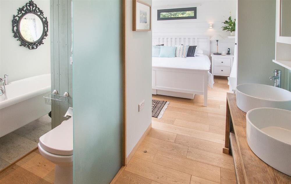 En-suite bathroom with roll top bath and separate shower - there is a partition, rather than a door between the bedroom and bathroom areas