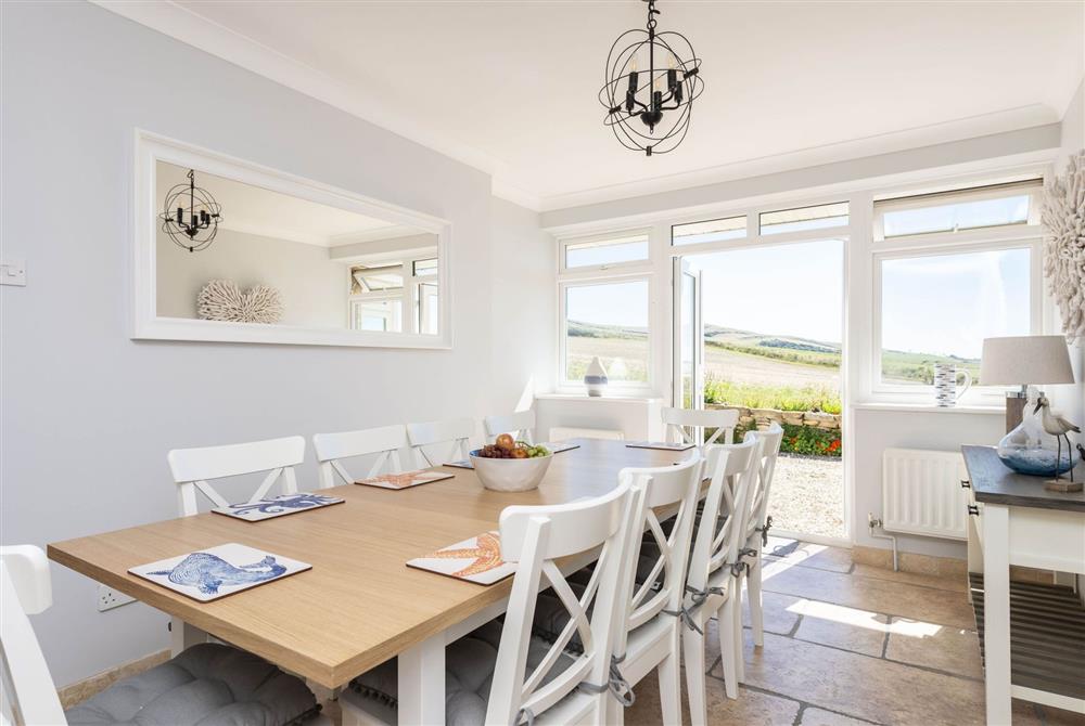 Dining room with french doors and expansive views at Chesil Watch, Abbotsbury