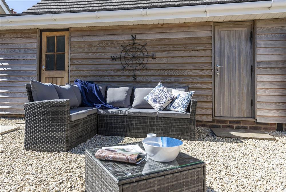 The courtyard seating area and separate utility room behind at Chesil Watch, Abbotsbury