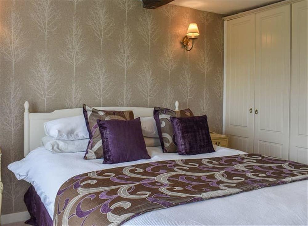 Bedroom. Kingsize bed with views across Morecambe Bay at Chestnut Cottage in Grange-over-Sands, Cumbria