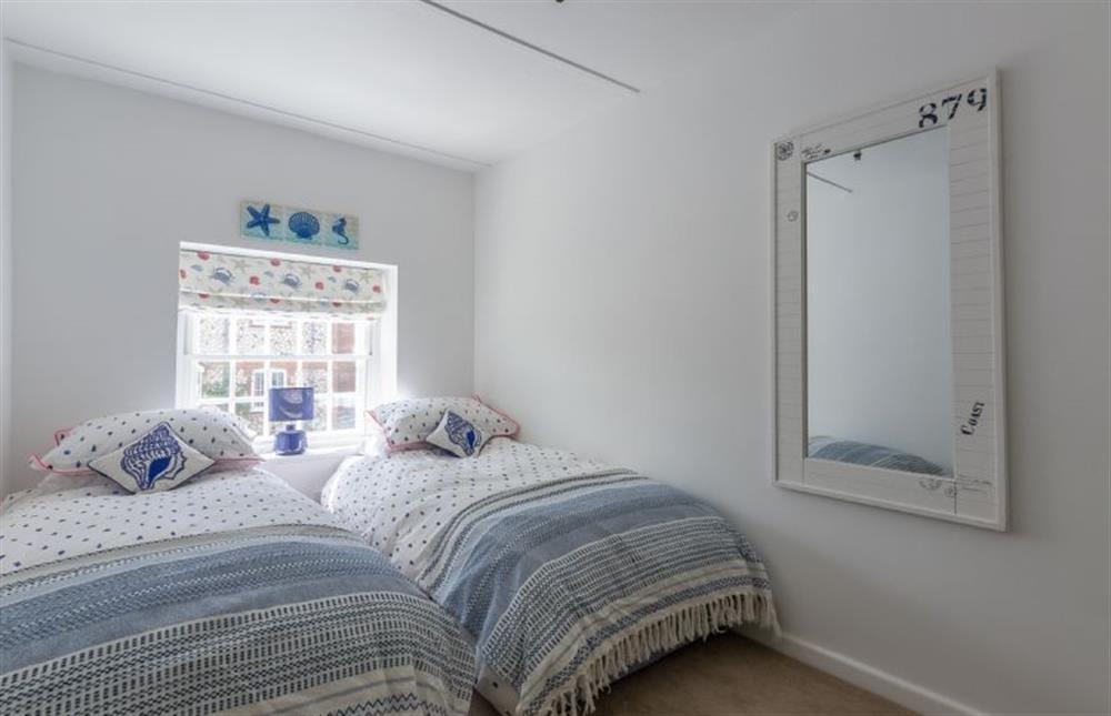 First floor: Bedroom three has two single beds and views to the rear garden at Chestnut Cottage, Thornham near Hunstanton