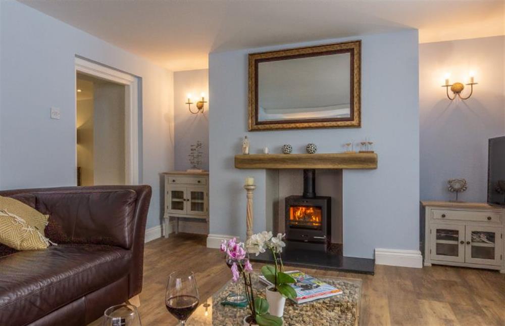 Ground floor: Cosy up in front of the wood burning stove in the spacious sitting room at Chestnut Cottage, Thornham near Hunstanton