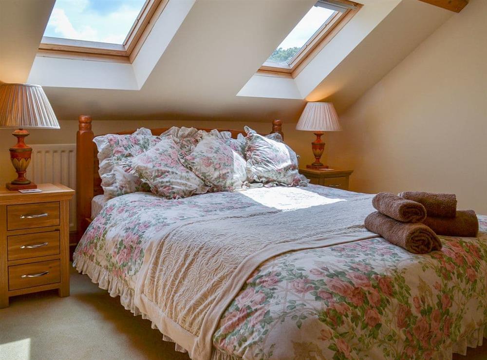 Beamed double bedroom with sloping ceiling at Binbrook House Mews, 