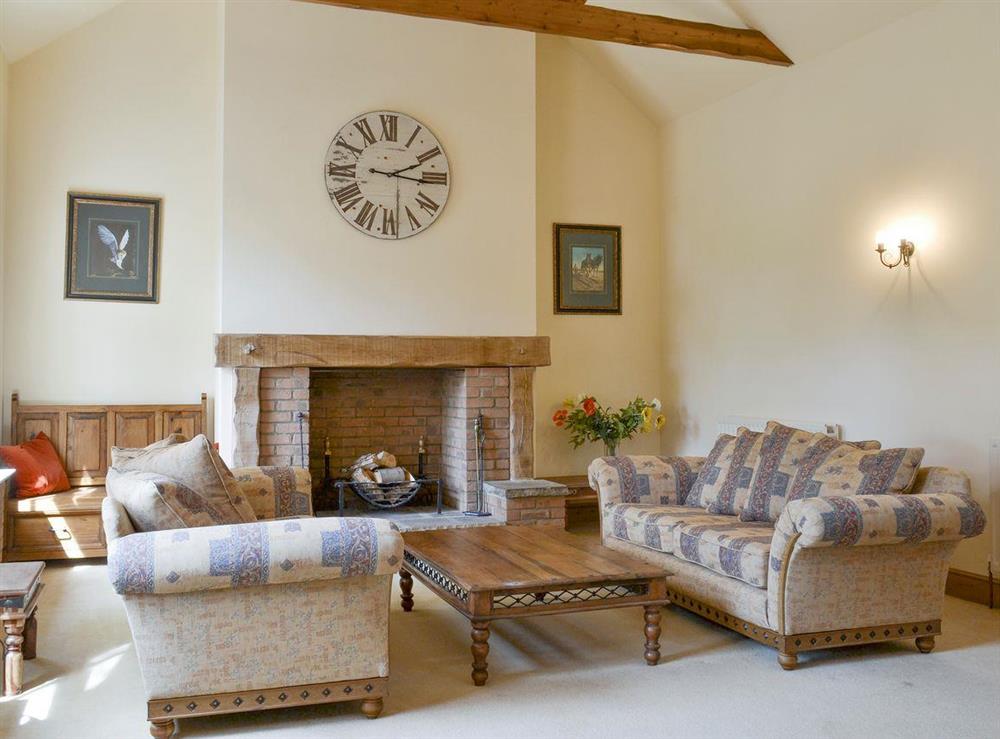Stylish living room with exposed wood beams at Binbrook House Mews, 