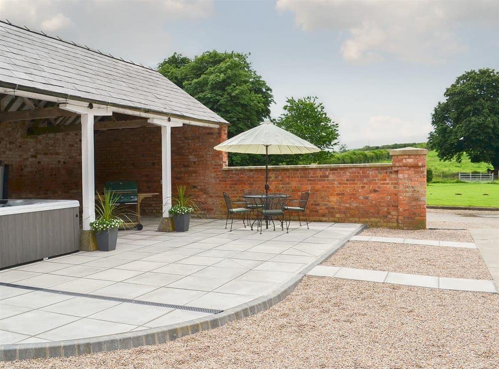 Paved patio and BBQ area with luxurious covered hot tub - shared facilities at Chestnut Farm Mews, 