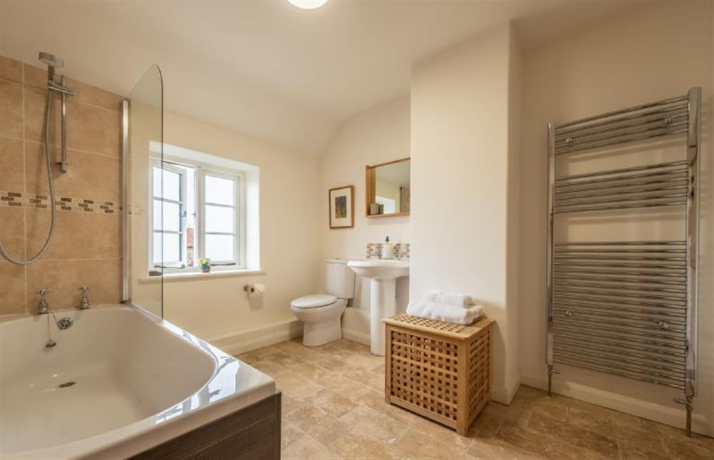 First floor: The spacious bathroom has bath with shower over at Chiffchaff Cottage, West Raynham near Fakenham